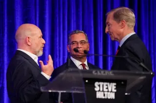 three men speak with each other