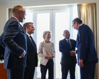 Friedrich Merz, Emmanuel Macron, Antonio Costa and Aleksandar Vičić stand in a bright room, smiling and conversing