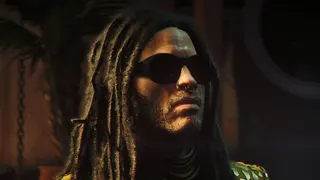 Lenny Kravitz's character Bawma wearing sunshades and looking off camera in 007 First Light.