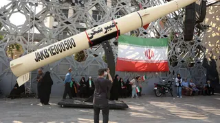 File photo of Iranians next to a symbol of a Kheibar missile taken during a rally in Tehran on June 4, 2026.