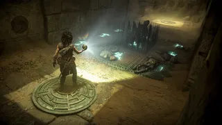 A dark curly haired woman holds a ball that emits light onto a spike trap before her. It's Sophia in Resonance: A Plague Tale Legacy.