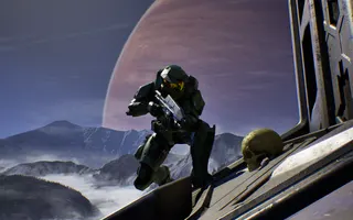 Master Chief stands next to a skull in Halo Campaign Evolved