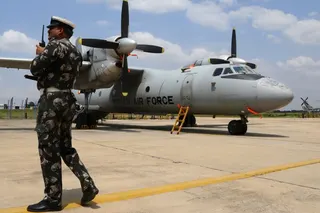 An Indian Air Force (IAF) official talks on his radio transmitter next to the Antonov AN-32 twin engine turboprop transport aircraft at an air base ahead of the Air Force Day celebrations in Bangalore, India, Tuesday, Oct. 4, 2016. The IAF was established on Oct. 8, 1932 and is the fourth largest air force in the world.