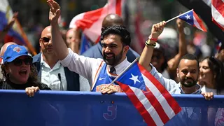 Mayor Zohran Mamdani standing at the National Puerto Rican Day Parade in New York City