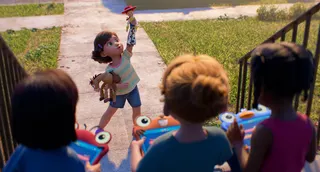 A CGI image of a young girl playing with a toy horse and toy cowgirl while three other girls holding tablet devices watch on in dismay.