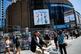 People walk and bike by Madison Square Garden in New York on June 8.
