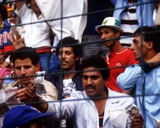 An Algerian fan waves a banknote showing his disgust as West Germany’s infamous 1-0 win over Austria played out at the 1982 World Cup