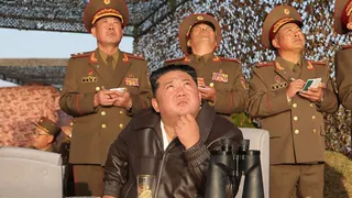 North Korean leader Kim Jong Un, with his daughter, observes what state media said was a test launch of an upgraded surface-to-surface ballistic missile in North Korea on April 19, 2026
