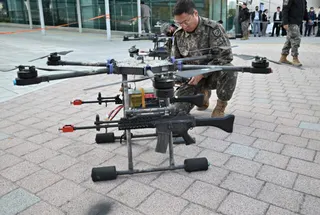 A South Korean soldier checks a drone equipped with rifles during an anti-terror drill at the Kintex exhibition centre in Goyang on October 27, 2022.