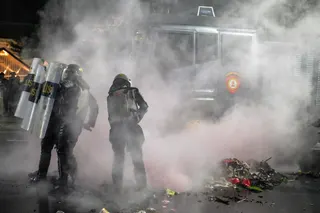 Riot police put out a fire during following clashes during protest against a rise in non-subsidised fuel prices, inefficient government spending and military involvement in civilian affairs and the government's free school meals programme (MBG) in Surabaya on June 26, 2026. — AFP pic