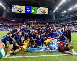 Cape Verde’s players and staff celebrate on the pitch in Houston