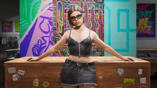 An in-game screenshot from GTA 6 showing a woman inside a shop in a short black top and a skirt with her arms resting on a desk behind her and a colourful background. She is wearing black sunglasses and has short brown hair.