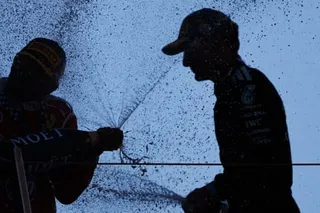 Lewis Hamilton and George Russell spray each other on the podium in Barcelona