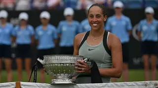 Madison Keys holds Eastbourne trophy at net