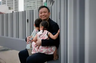 Pastor Edric Sng with two of his six children on May 29. When he got married, he thought he would have one – enough to satisfy his wife.