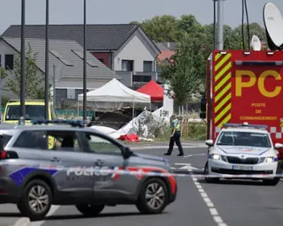 Emergency services at the scene of the crash in a suburban setting.