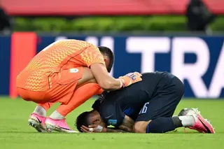 Uruguay’s goalkeeper Sergio Rochet (left) consoling his defender Mathias Olivera after a 1-0 group loss to Spain eliminated them from the 2026 World Cup.
