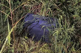 A suitcase in which police later found the body of a 17-year-old Thai girl lies in a grassy area near a railway track where it was discovered in Pattaya City, Thailand, June 27, 2026. — Reuters pic