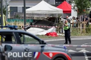 A rescuer works at the site of a plane crash in Tomblaine, France.