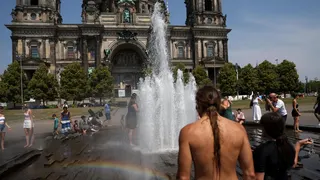 People cool off in the fountain in front of the Berlin Cathedral Berliner Dom during the ongoing heatwave.