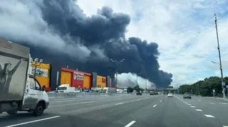 Black smoke billows over the Moscow ring road from a fire at an oil refinery