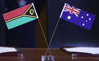 The national flags of Australia (right) and Vanuatu are seen on a table during Vanuatu Prime Minister Jotham Napat’s visit to Parliament House in Canberra on Monday. Photo: AFP