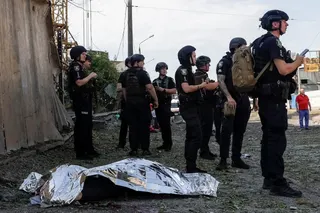 Police officers stand near the body of a resident killed during a Russian air strike in Kharkiv, Ukraine, on Monday. Photo: Reuters