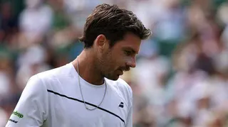 Cameron Norrie looks down during his first-round match at Wimbledon