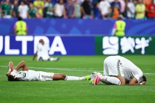 Abdulelah Al-Amri and Ali Lajami look dejected after the match as Saudi Arabia are eliminated from the World Cup [Pedro Nunes/Reuters]