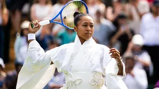 Naomi Osaka wears an all-white kimono as she prepares to warm-up before her first-round match at Wimbledon