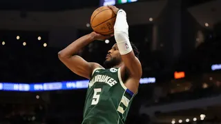 Malik Beasley of the Milwaukee Bucks shooting a three-point shot during a basketball game