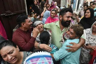 Relatives mourn after a roof collapse at a tutoring centre killed 14 children in Lahore, Pakistan on Tuesday. Photo: Reuters