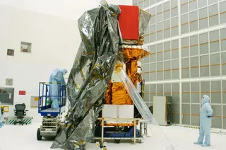 This handout photo released by NASA on July 31, 2004, shows the Swift spacecraft being unwrapped in Hangar AE at Cape Canaveral Air Force Station at Kennedy Space Center, Florida. — NASA pic
