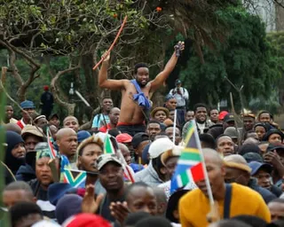 Crowd of people waving South Africa flags