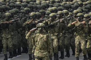 Royal Malaysia Army soldiers march in formation during National Day celebrations in Kuala Lumpur on August 31, 2022. Photo: AP