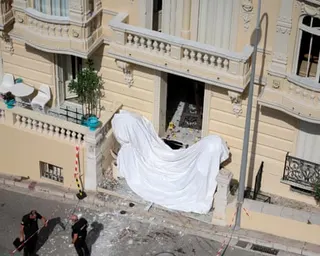 Members of a bomb disposal team operate the day after an attack involving an explosive device in the lobby of a residential building, in Monaco.