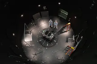 This photo provided by NASA shows Kieran Wilson, LINK's principal investigator, and Hunter Robertson, a space systems engineer, both at Katalyst Space, standing next to their spacecraft inside the SES (Space Environment Simulator) at NASA's Goddard Space Flight Center in Greenbelt, Maryland, April 17, 2026, ahead of thermal vacuum testing.