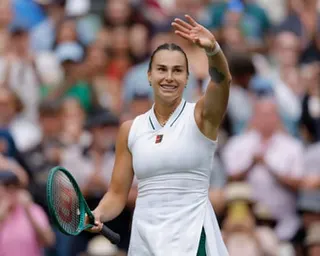 Aryna Sabalenka acknowledges the crowd at Wimbledon after winning
