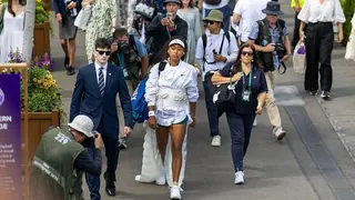 Naomi Osaka walks through the Wimbledon grounds