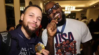 Steph Curry and LeBron James pose for a selfie with their Olympic gold medals