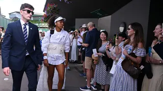 Naomi Osaka walks to her court wearing her latest outfit at this year's Wimbledon