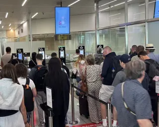 Passengers queue at passport control in the departures terminal of Brussels airport on 29 June 2026.