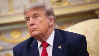 President Donald Trump wearing a blazer, white shirt and red tie.