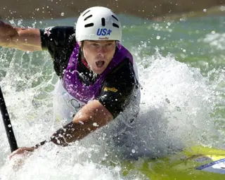 a man in a canoe navigates whitewater rapids