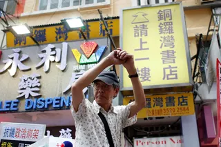 FILE PHOTO: Bookseller Lam Wing-kee greets supporters outside his Causeway Bay Books bookstore before taking part in a protest march in Hong Kong, China June 18, 2016.      REUTERS/Bobby Yip/File Photo