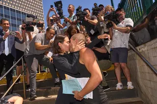 Angela Nikolau and Ivan Beerkus kiss after exiting New York City Criminal Court after their arraignment on July 2.
