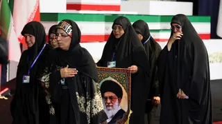 Women react near the coffins of Iran's late Supreme Leader Ayatollah Ali Khamenei and his family members.