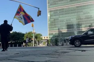 A man identified as Tibetan activist Lobga Rangzen walks carrying a Tibetan flag near the UN headquarters in New York, US on July 2, 2026.