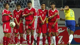 Chinese players grimace as Brazil's Roberto Carlos (right) unleashes a 14th minute free-kick for a goal during the 2002 World Cup