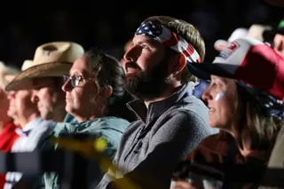 Supporters listen as Donald Trump speaks during a rally at Mount Rushmore National Memorial.